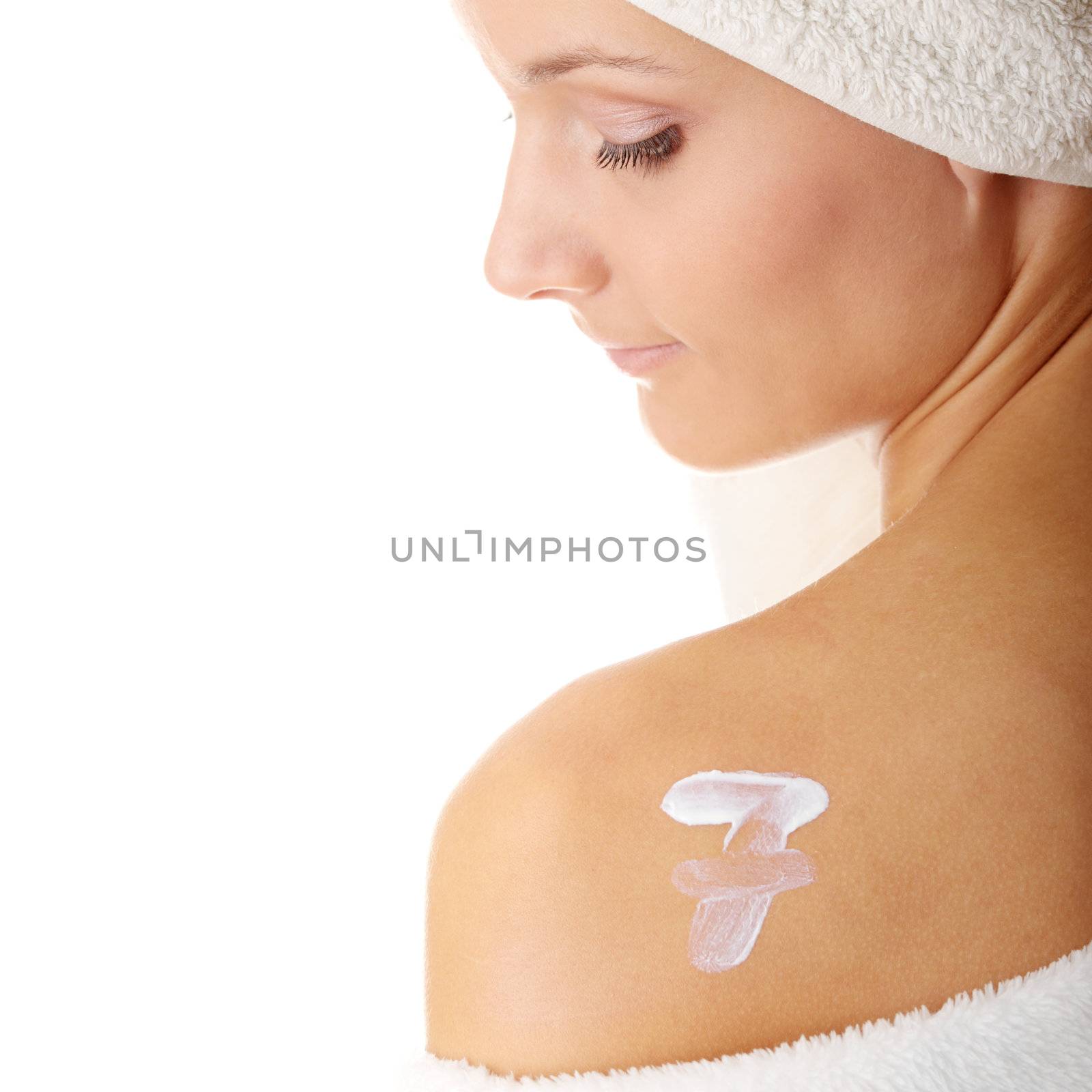 Skincare concept: back of beautiful nude woman with soft skin putting skincare product (cream) on her back - shaped seven
