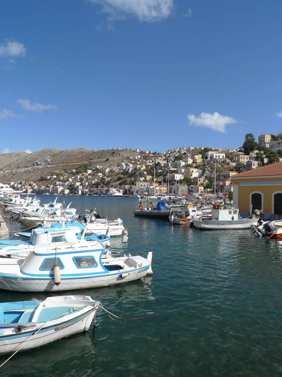 boats and yachts moored in a village in greece