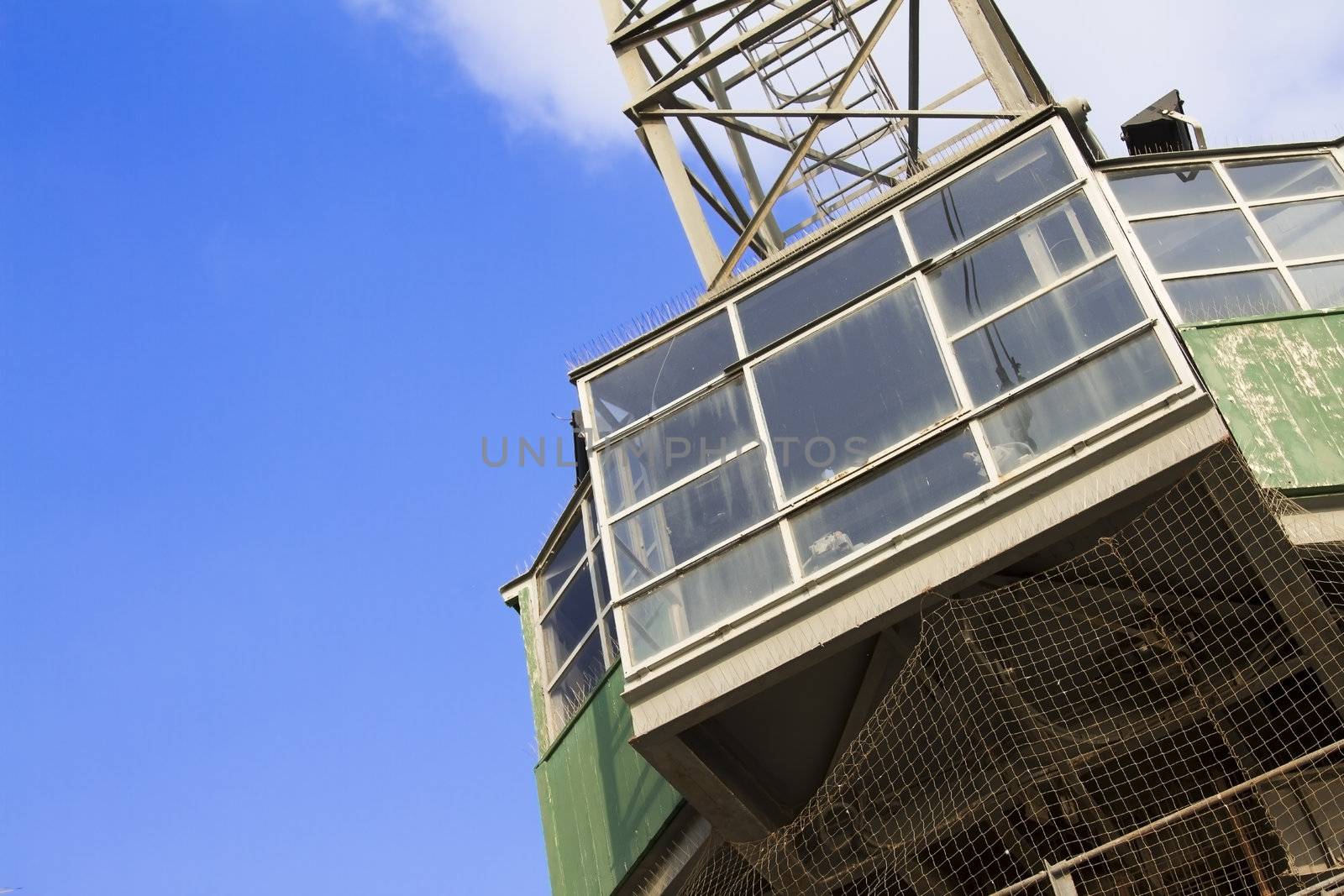 Bottom view of crane against blue sky.