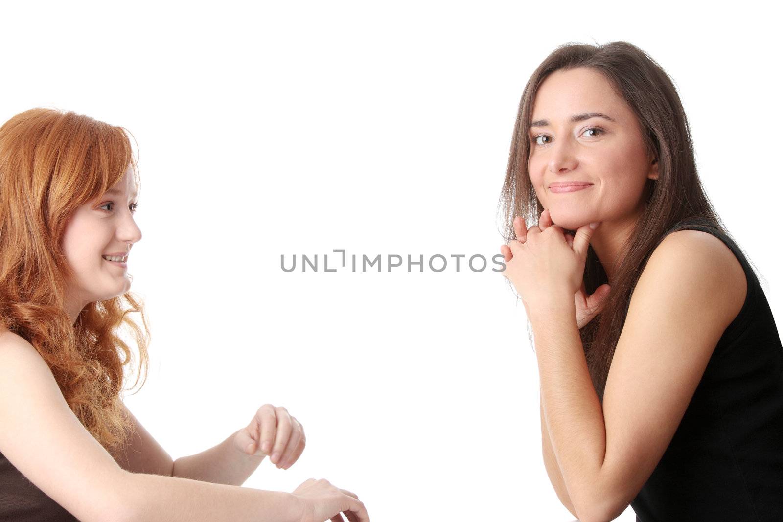 Two young womans talking isolated on white background