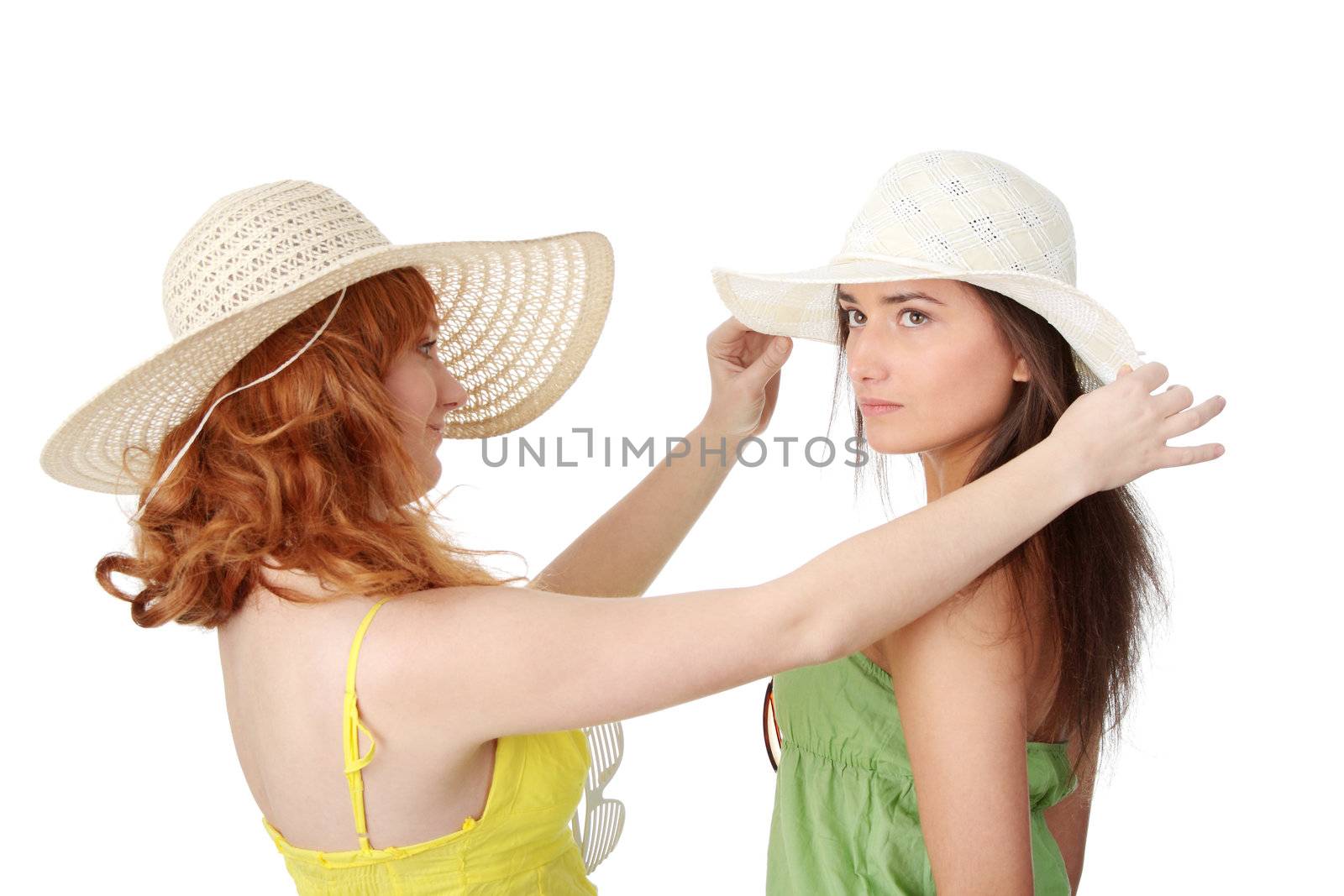 Two girlfriends in summer dress and hat over white background