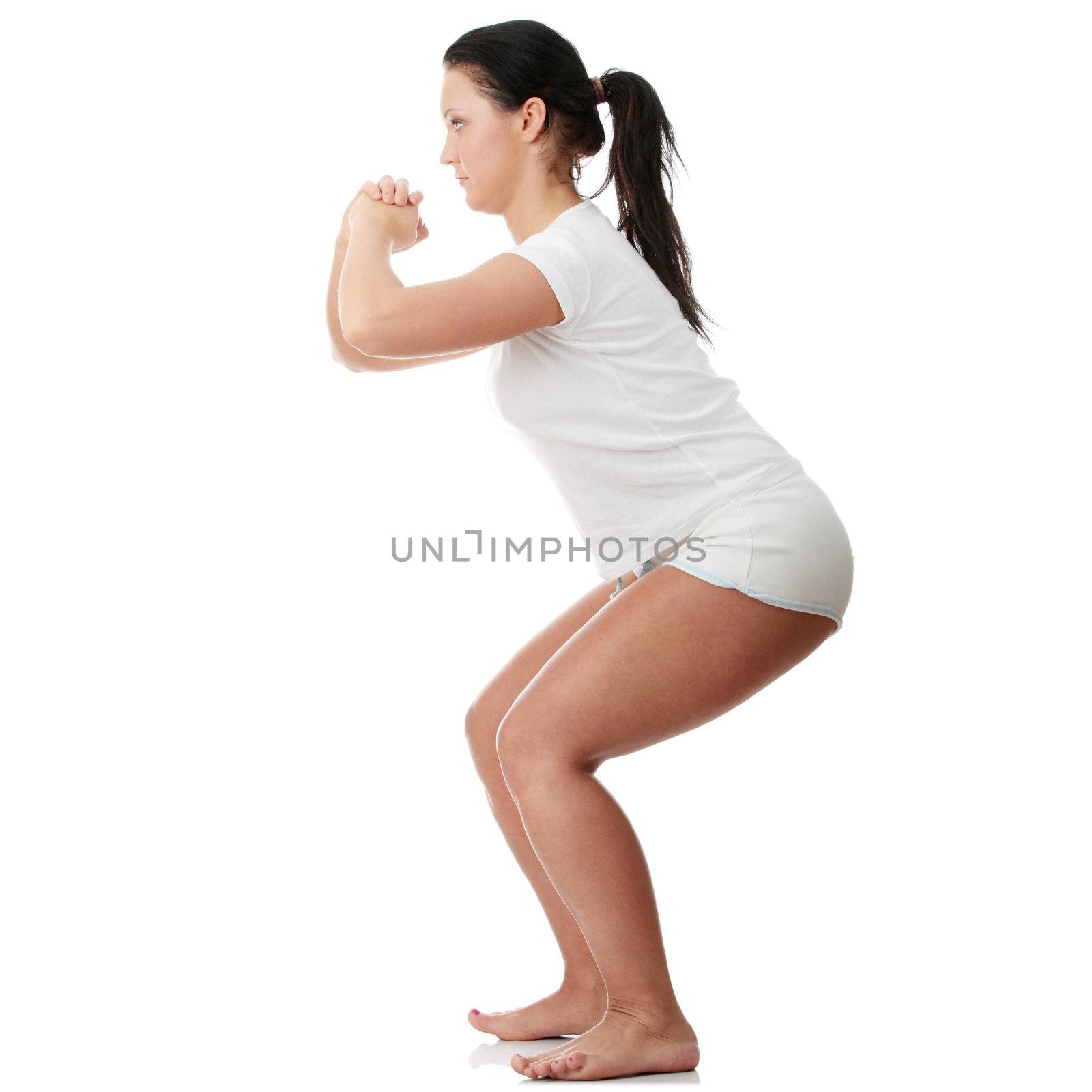 Young happy woman doing fitness exercises