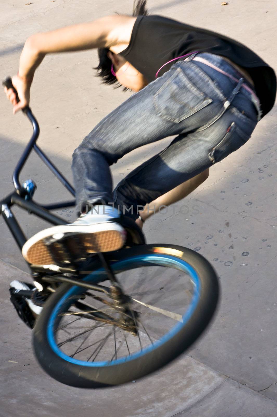 Asian Teenage boy on stunt bike ready to go