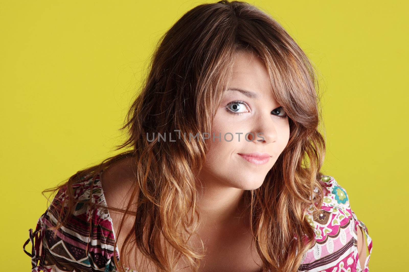 Teen woman portrait against green wall