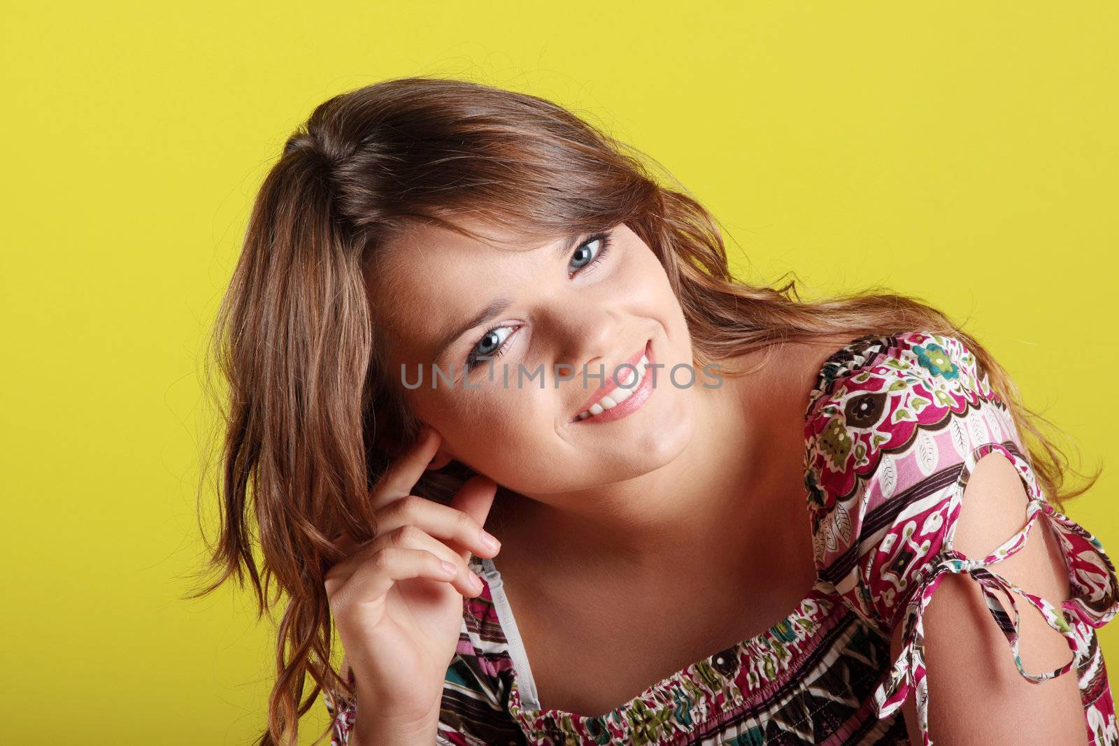 Teen woman portrait against green wall
