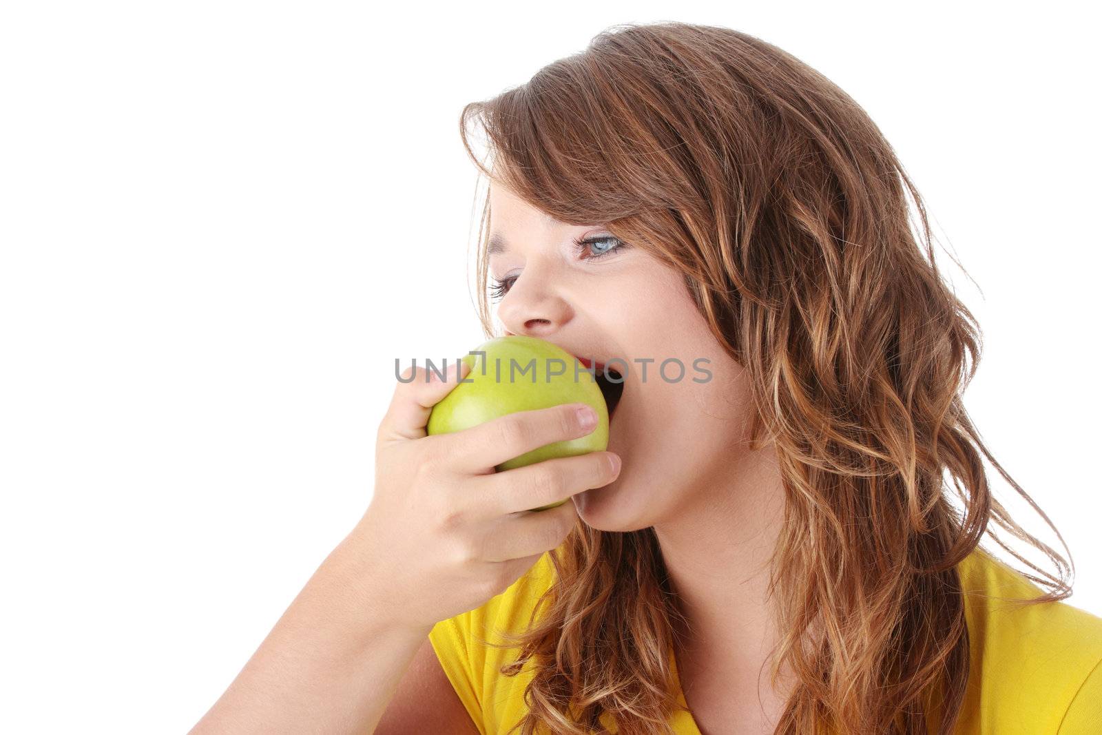 Teen girl eating grean apple isolated on white background
