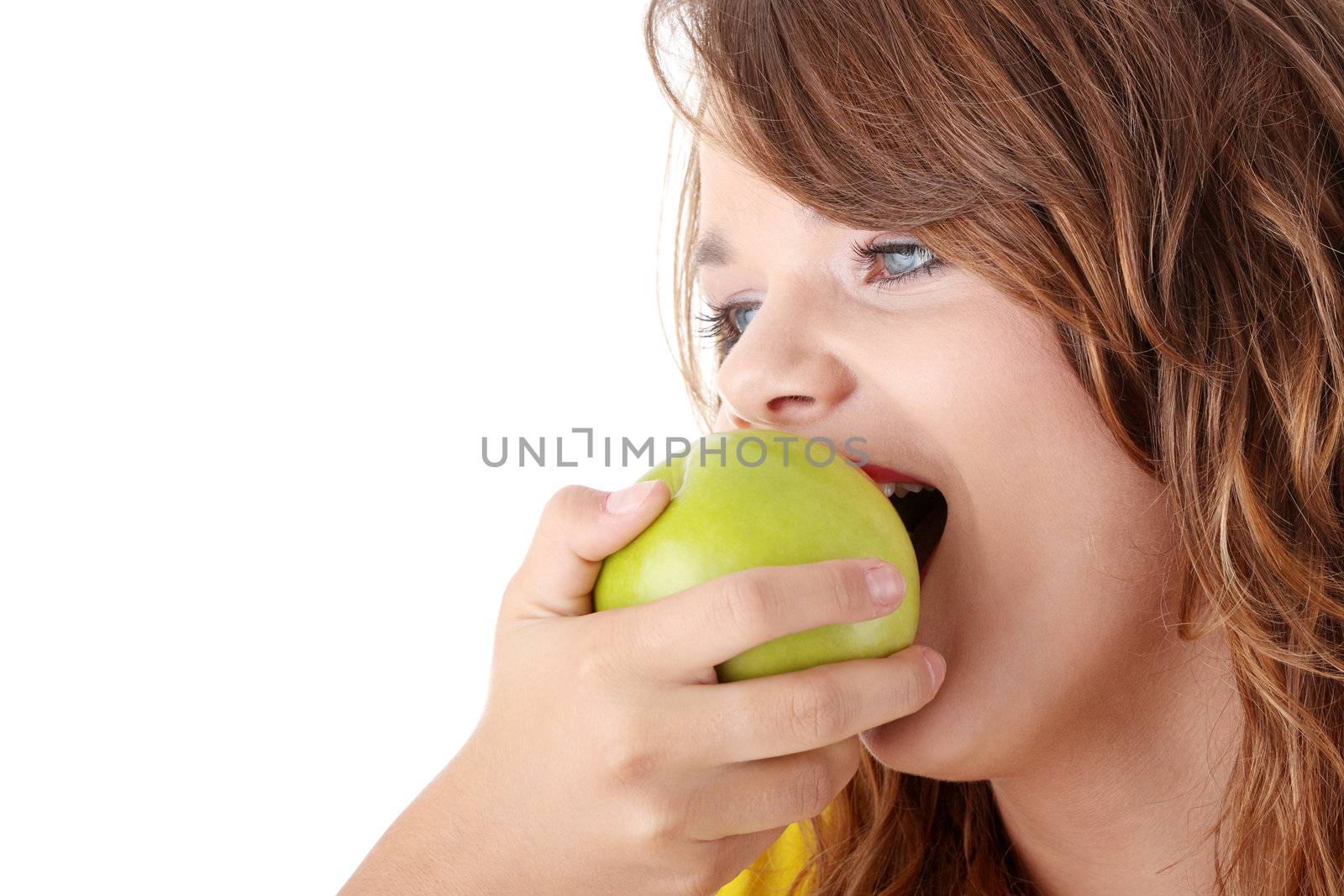 Teen girl eating grean apple isolated on white background