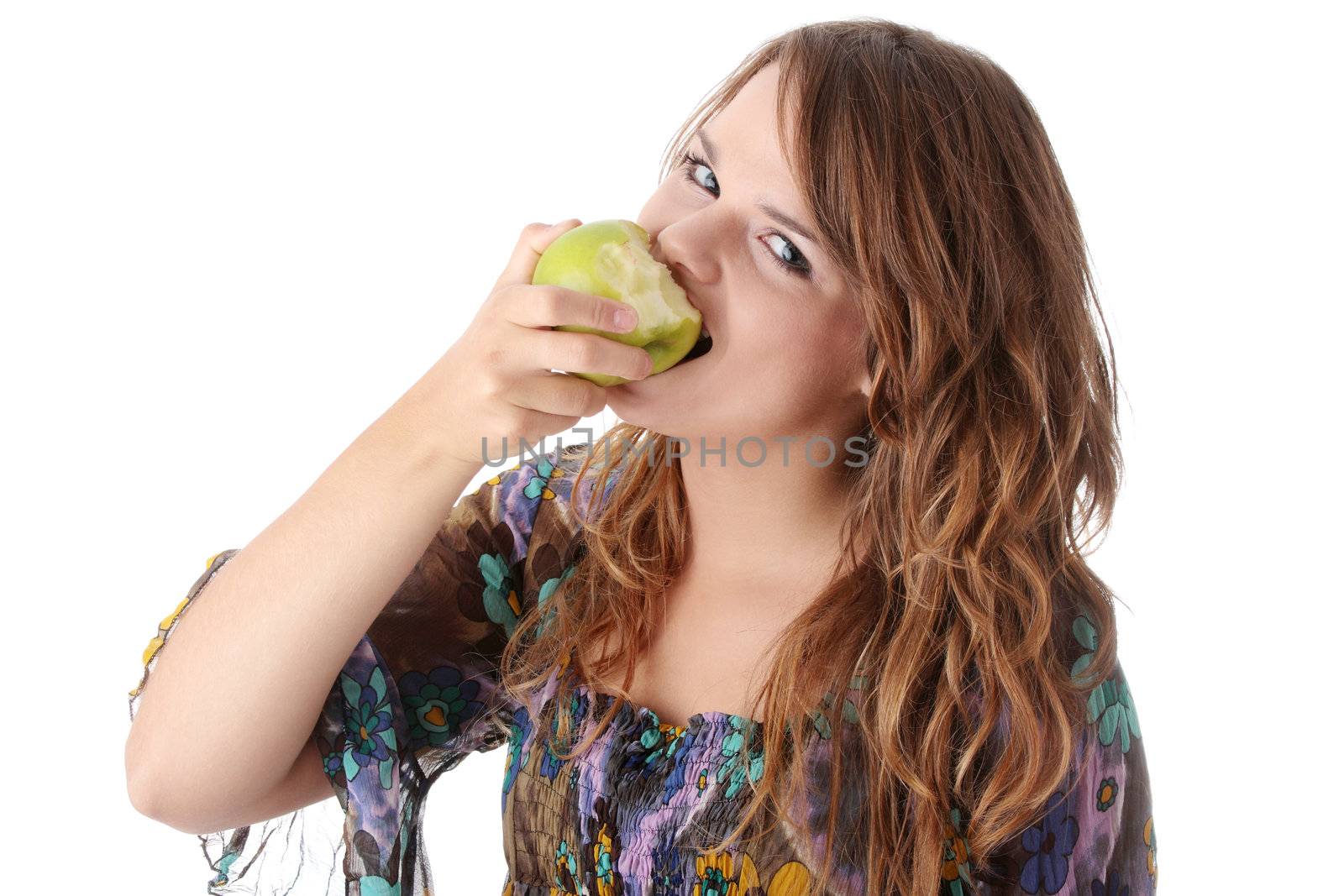 Teen girl eating grean apple isolated on white background