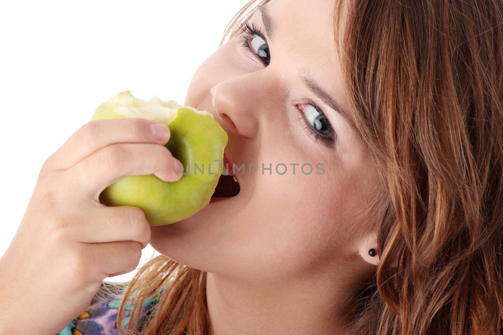 Teen girl eating grean apple isolated on white background