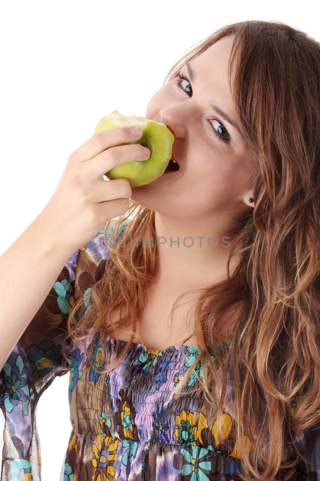 Teen girl eating grean apple isolated on white background