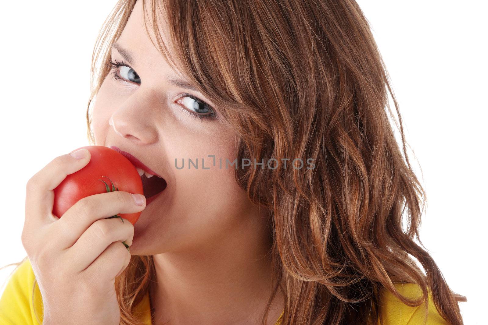 Young woman eating tomato isolated on white background