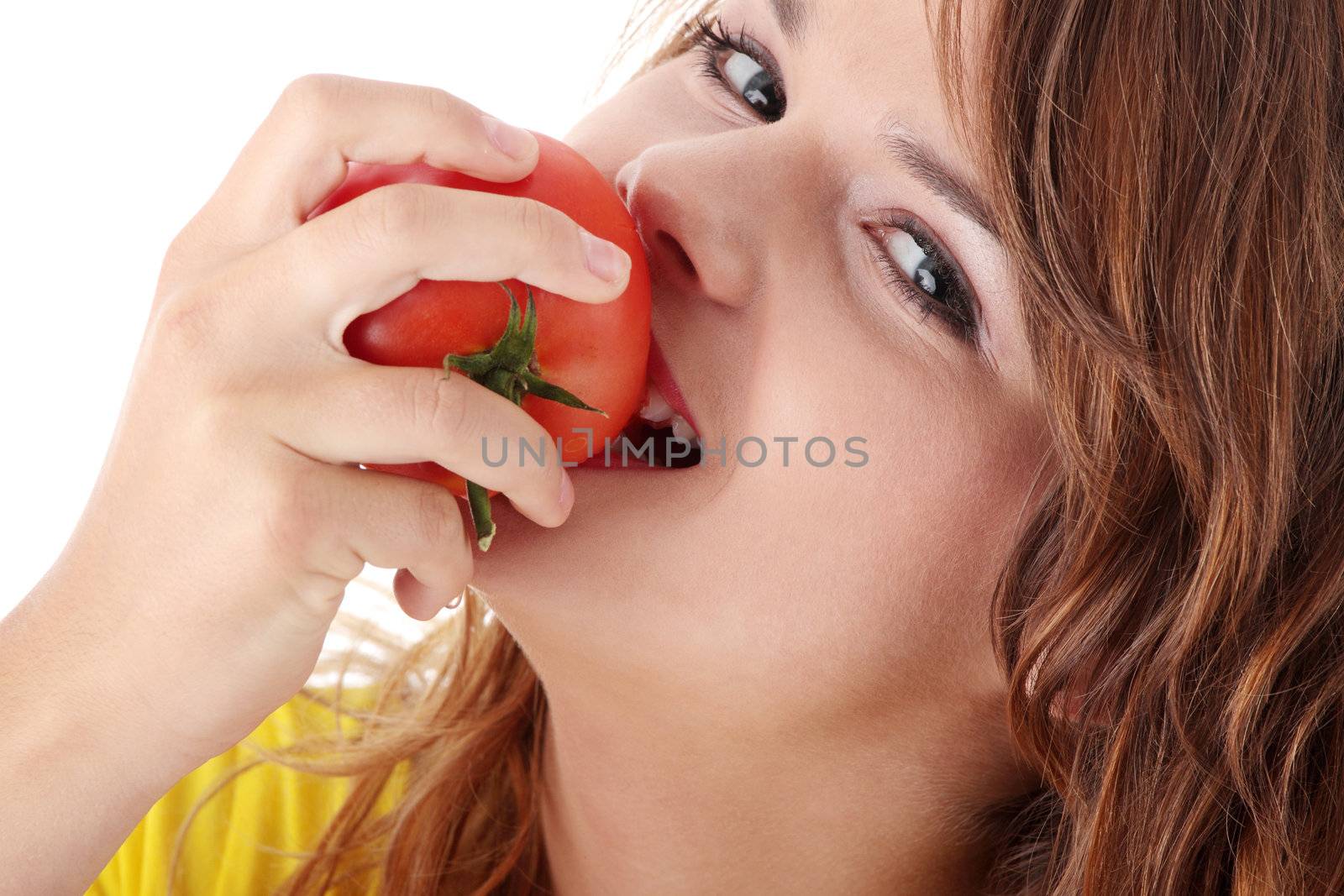 Young woman eating tomato isolated on white background