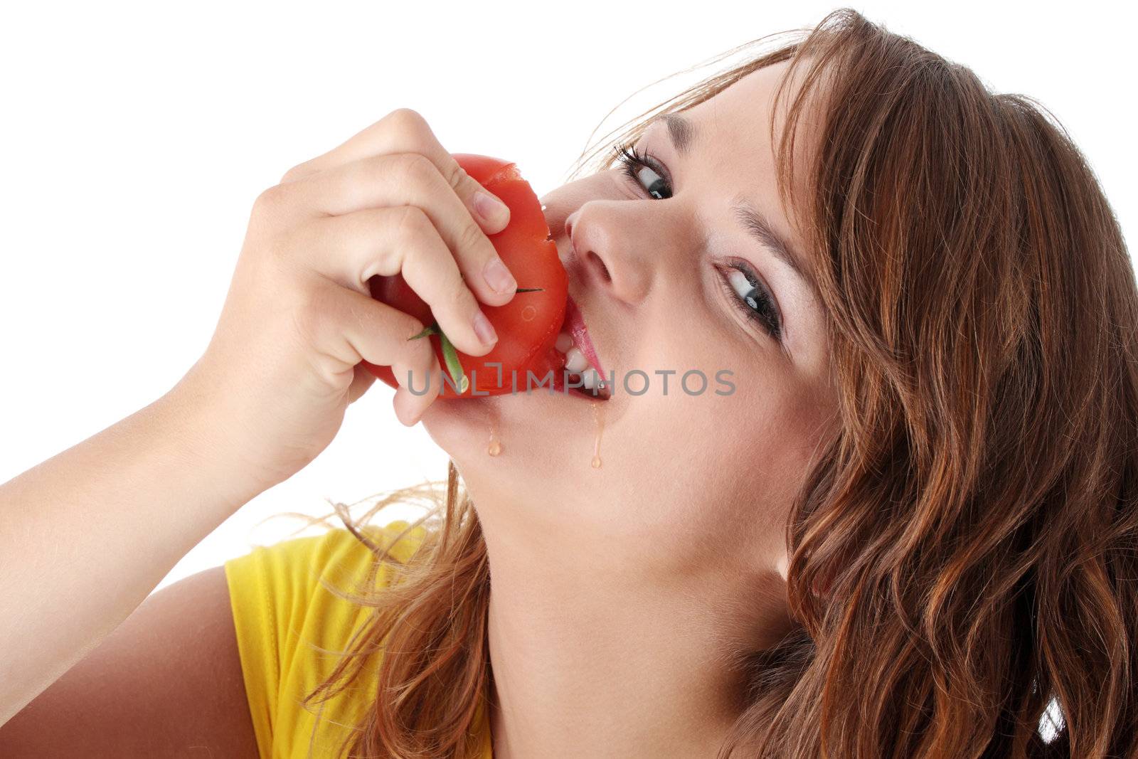 Young woman eating tomato isolated on white background