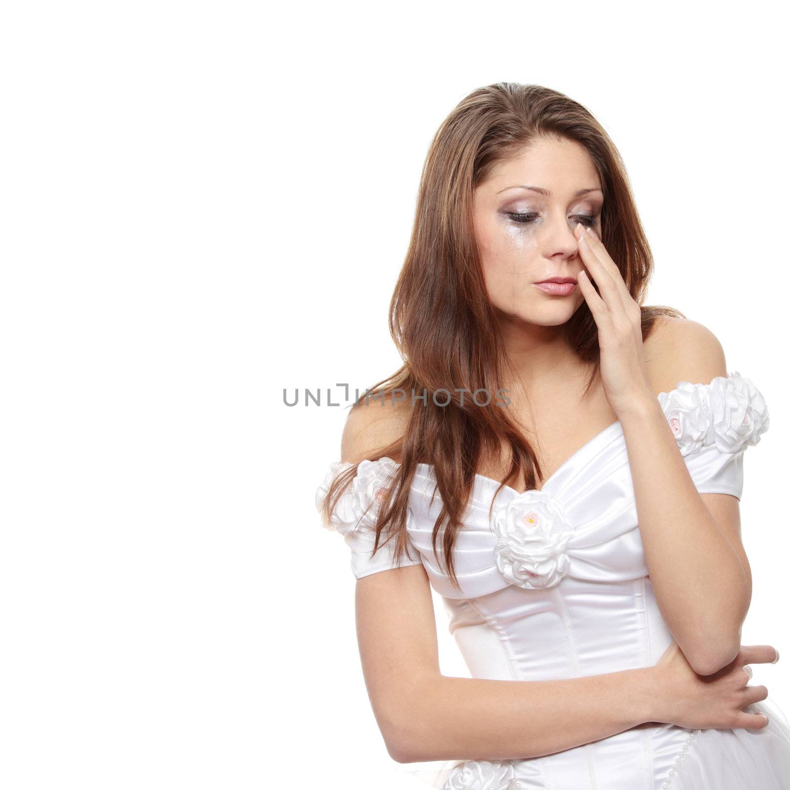 Beautiful young caucasian sad bride crying, over white background