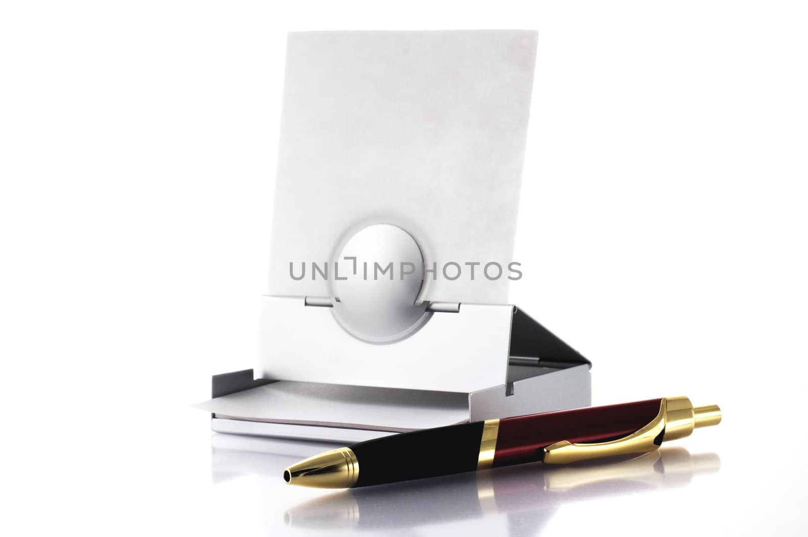 Pen and post-it box isolated on white by sil