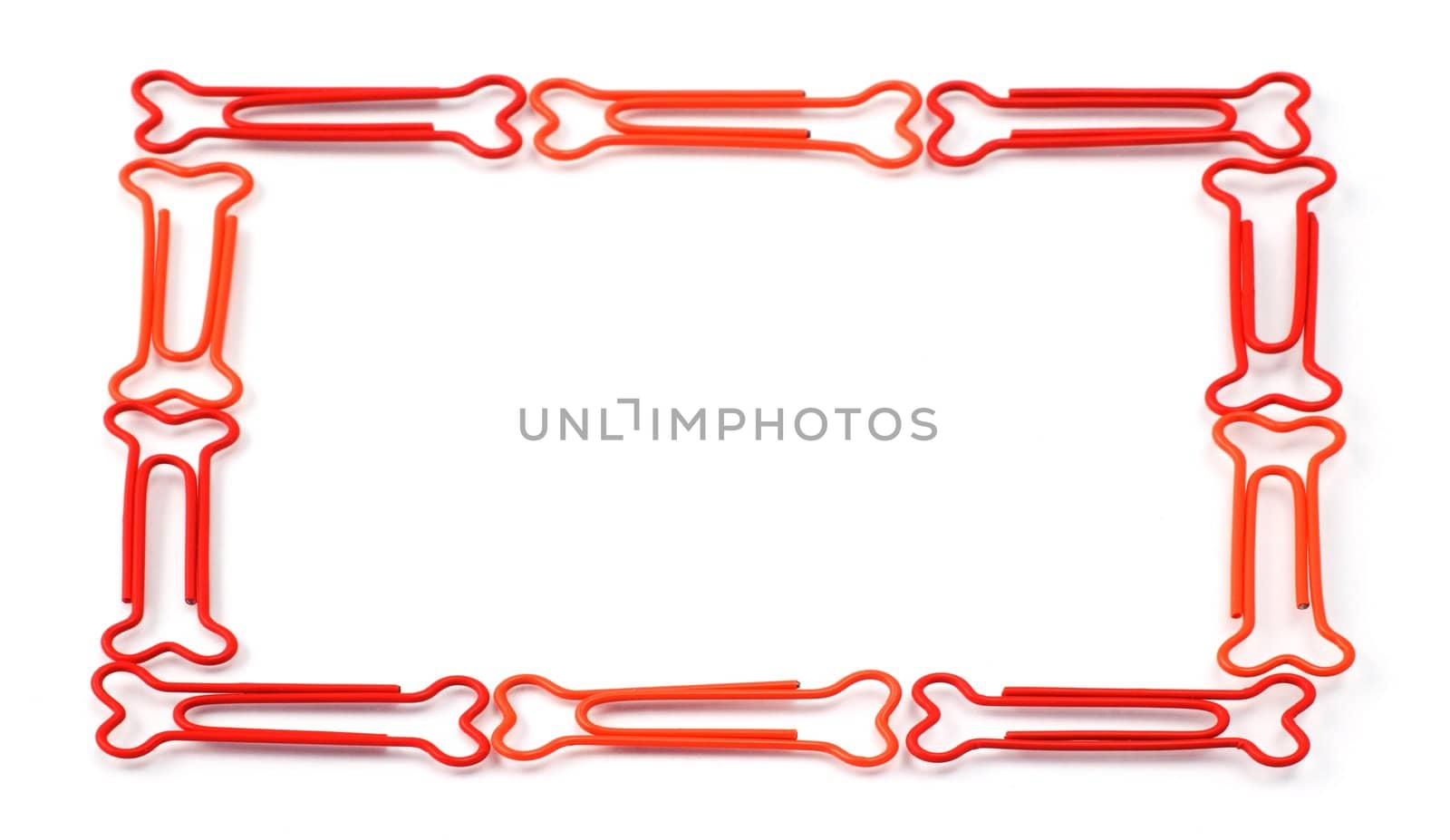 Colored bone-shaped paper clips isolated on white forming a frame