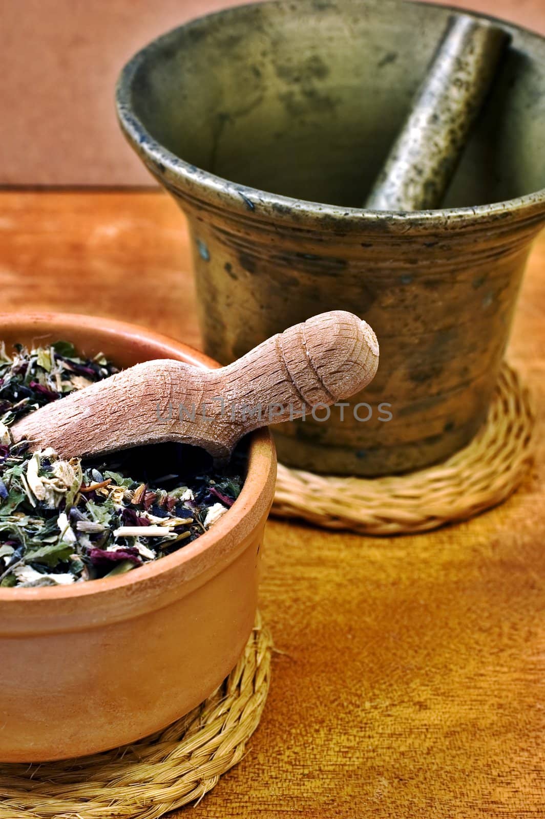 Mortar and bowl with herbs with selective focus