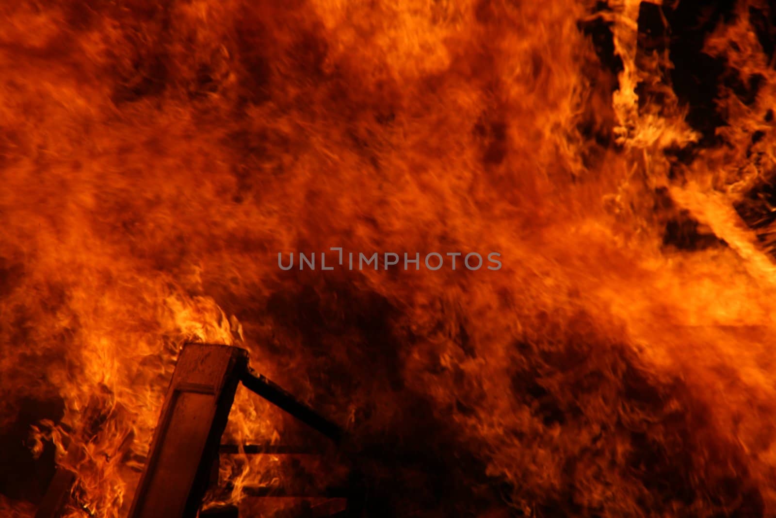 a house burning in flames, accidental fire
