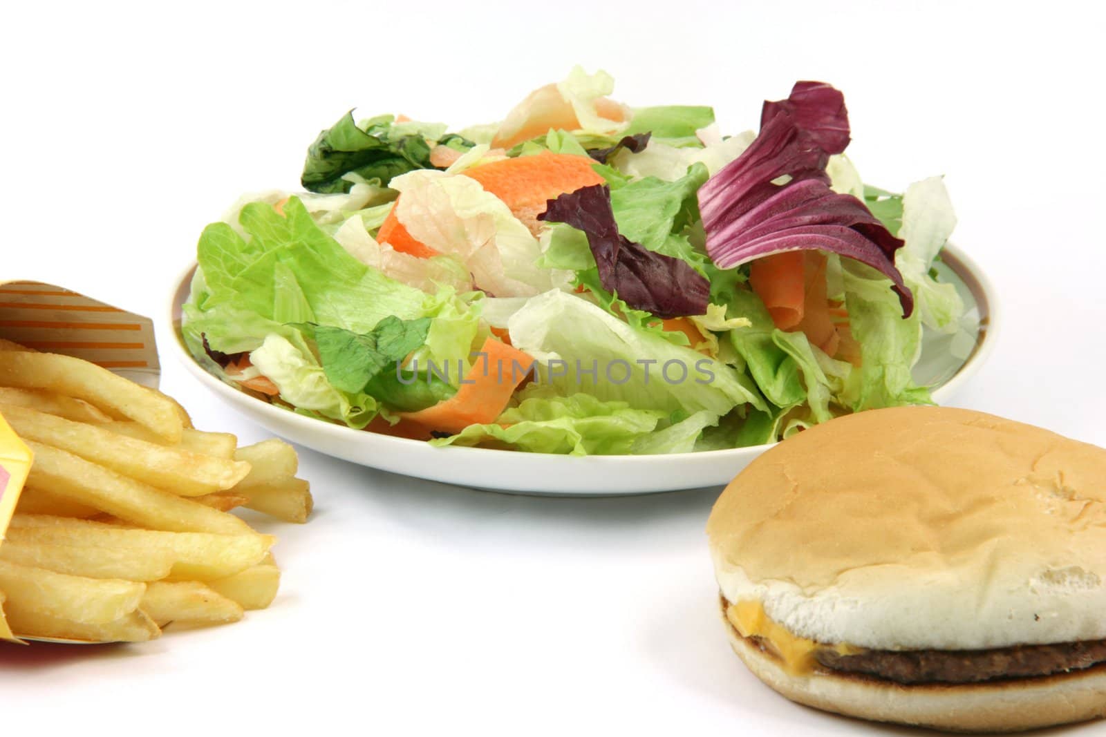 plate of salad cheeseburger and french fries in box isolated on white backround food concepts