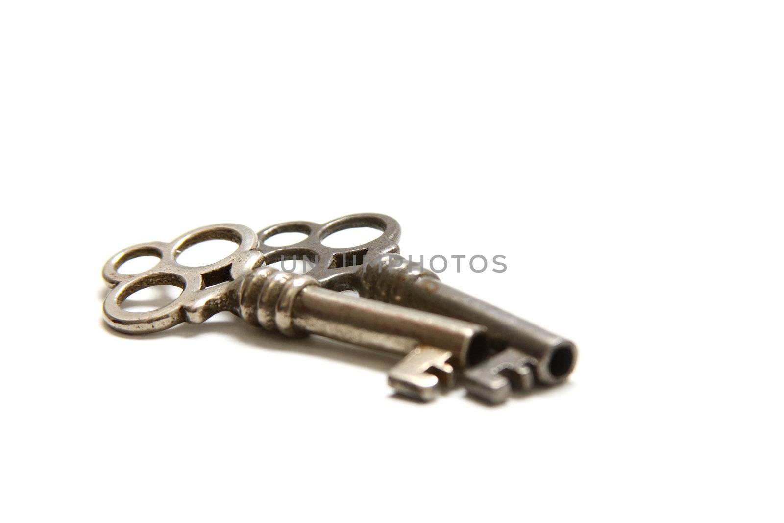 Isolated shot of two metal antique keys on white background