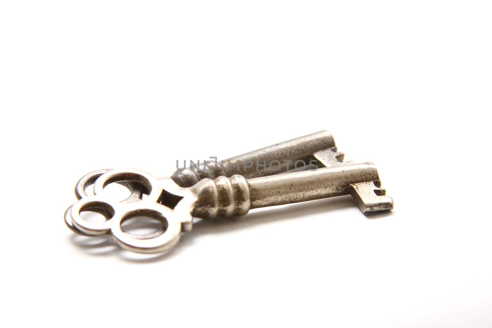 Isolated shot of two metal antique keys on white background