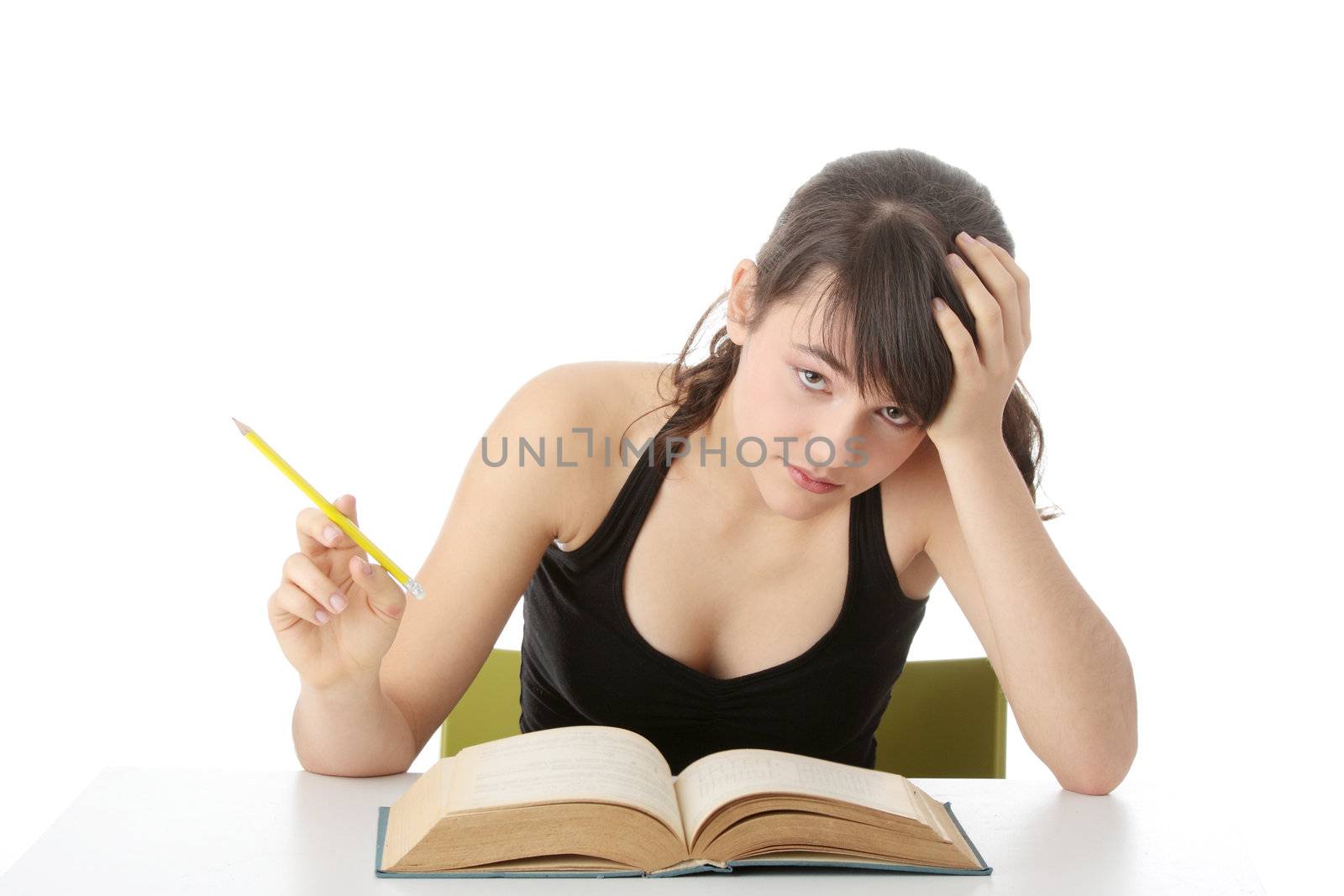 Teen girl learning at the desk , isolated on white