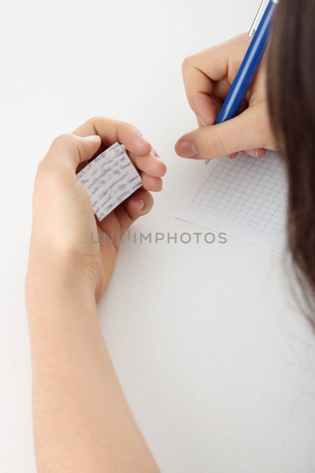 Young caucasian female student stands by school desk and cheat