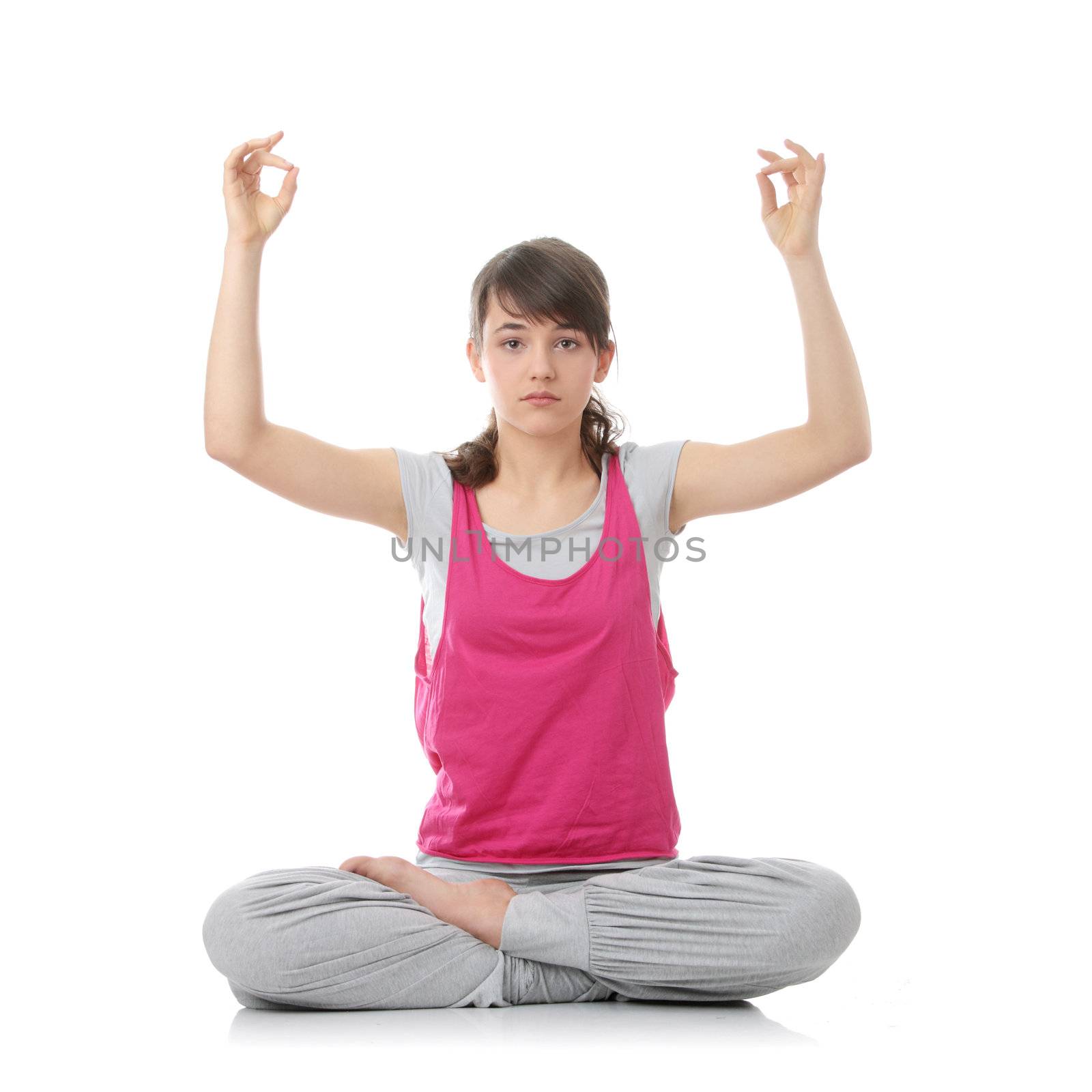 Teen woman training yoga, isolated on white