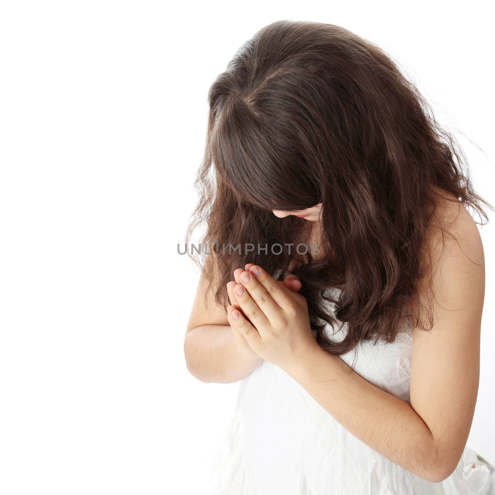 Closeup portrait of a young caucasian woman praying isolated on white background