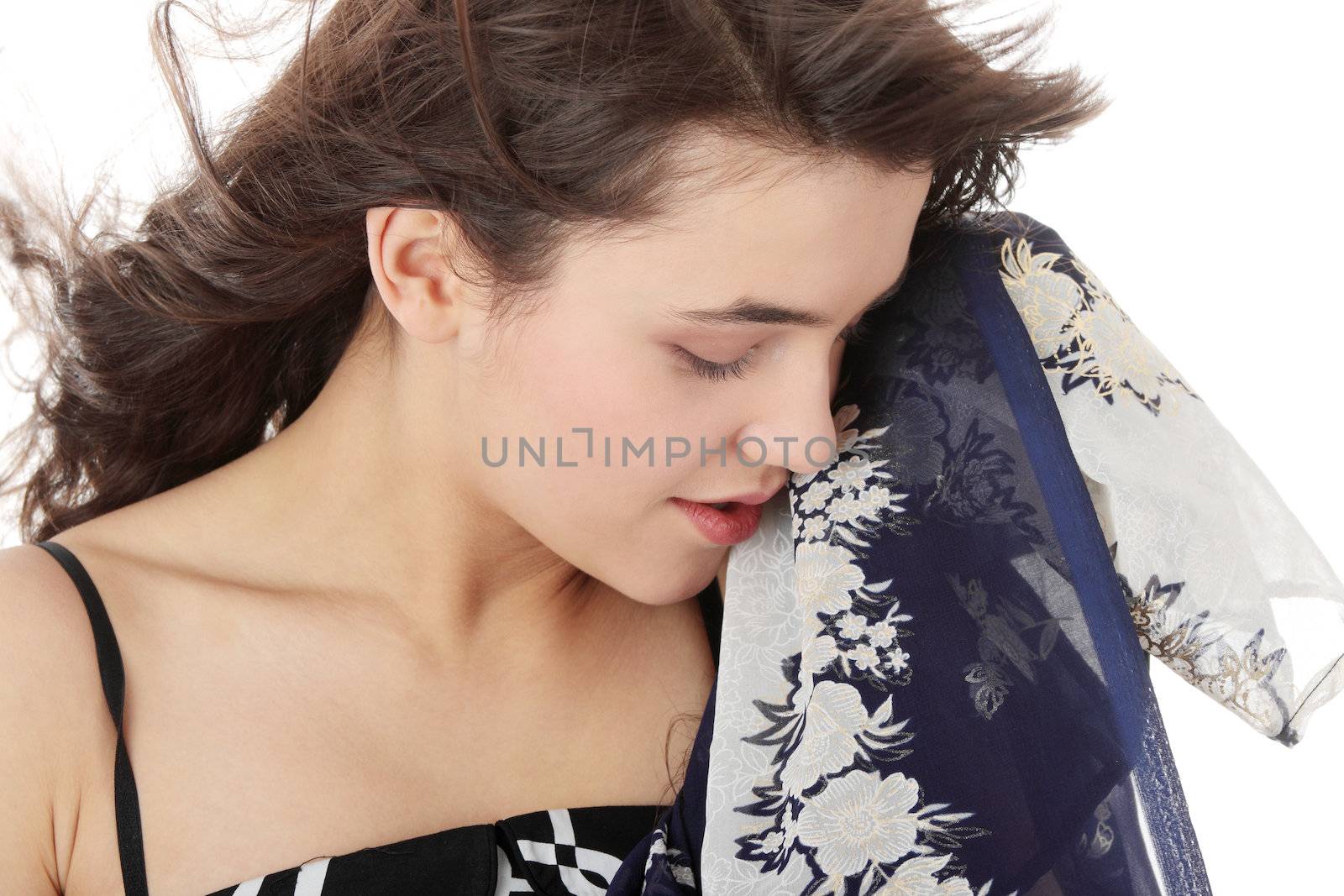 Young beautiful teen woman in elegant, dress dancing with wind (hair blowing), isolated on white background.
