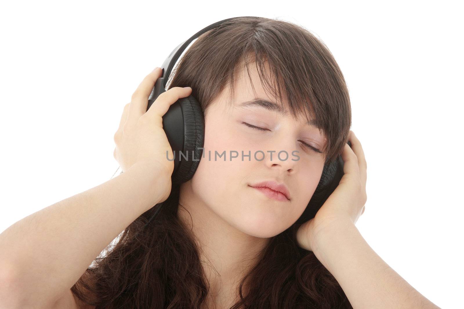 Young beautiful happy women listening music in headphones