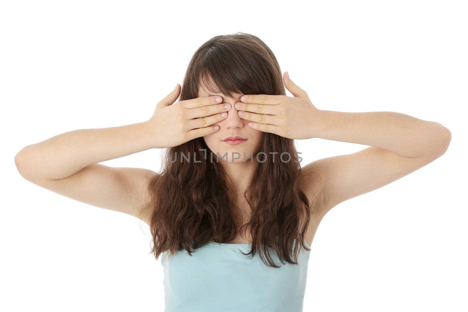Young teen woman covering her eyes isolated on white background