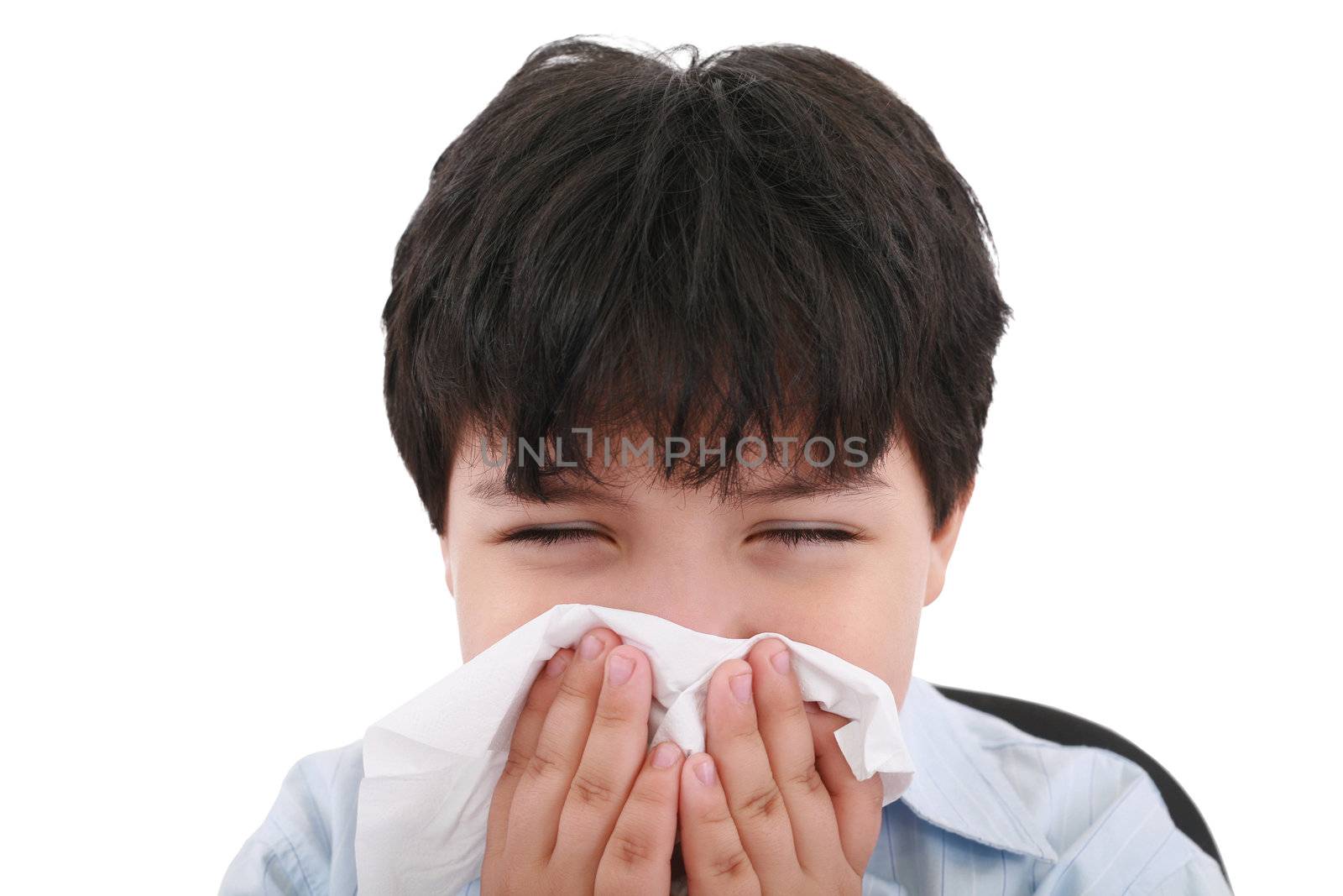 sick boy blowing his nose, white background