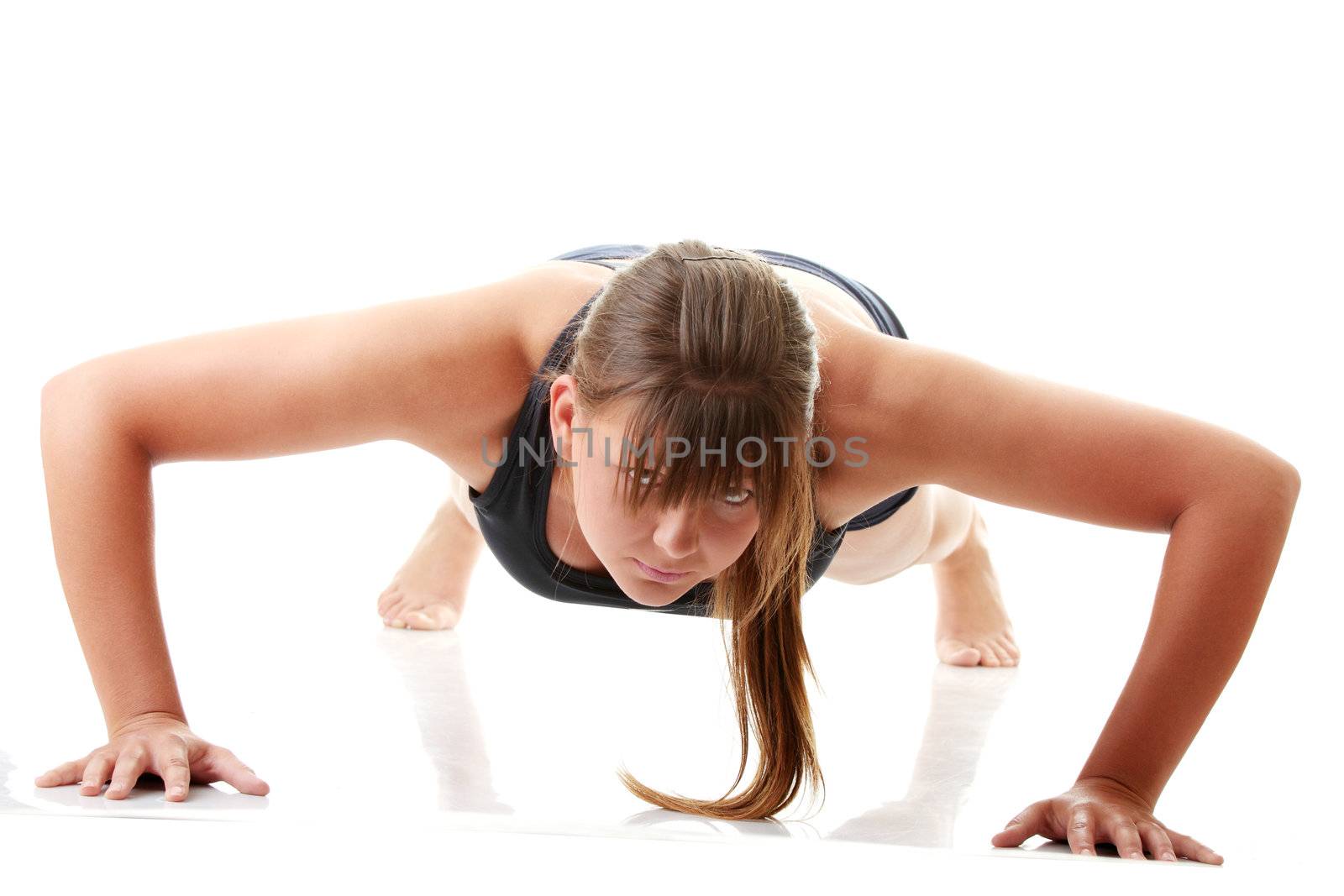 Relaxed fit woman doing exercise, isolated on white background.