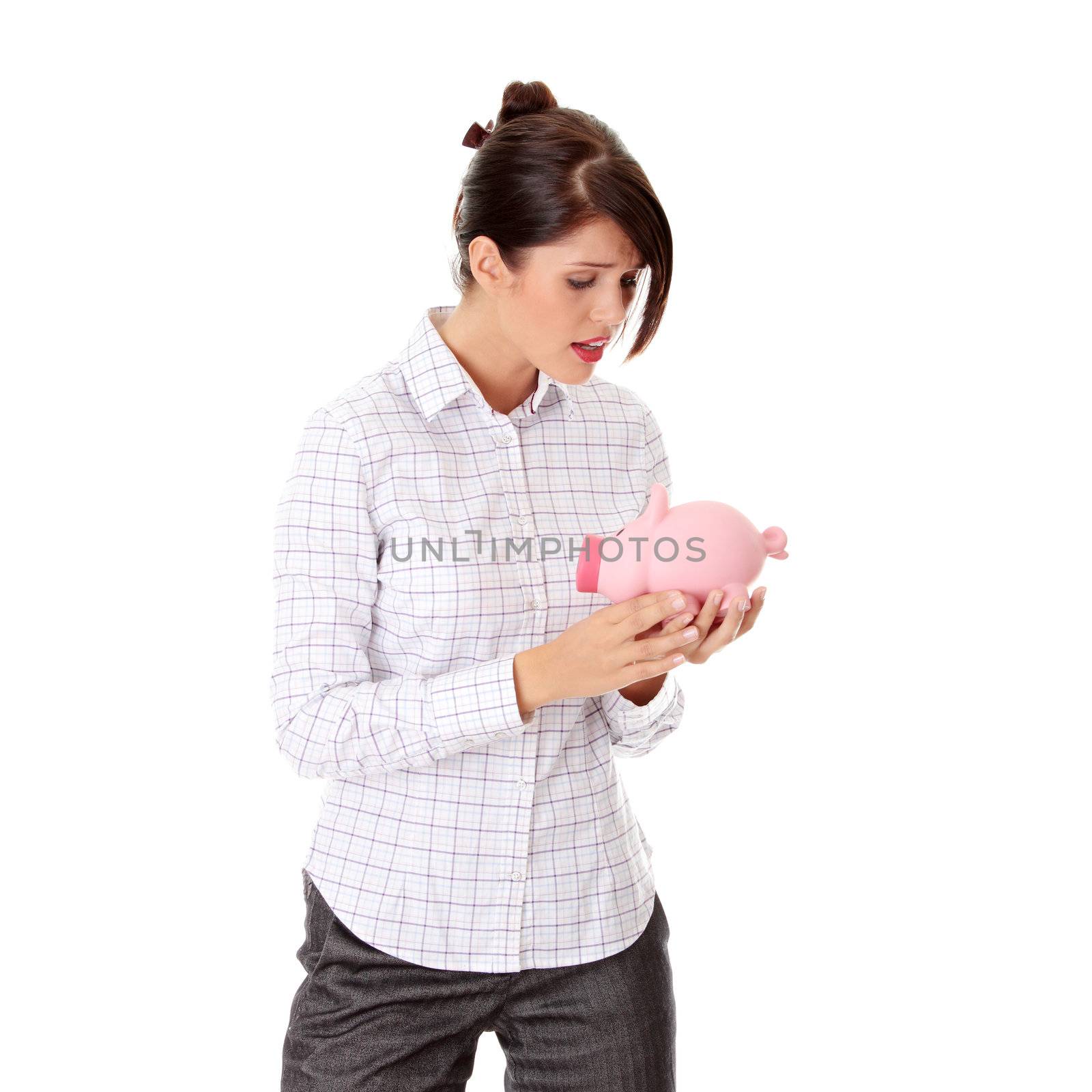 Young woman trying to get money from her piggy bank, isolated on white background