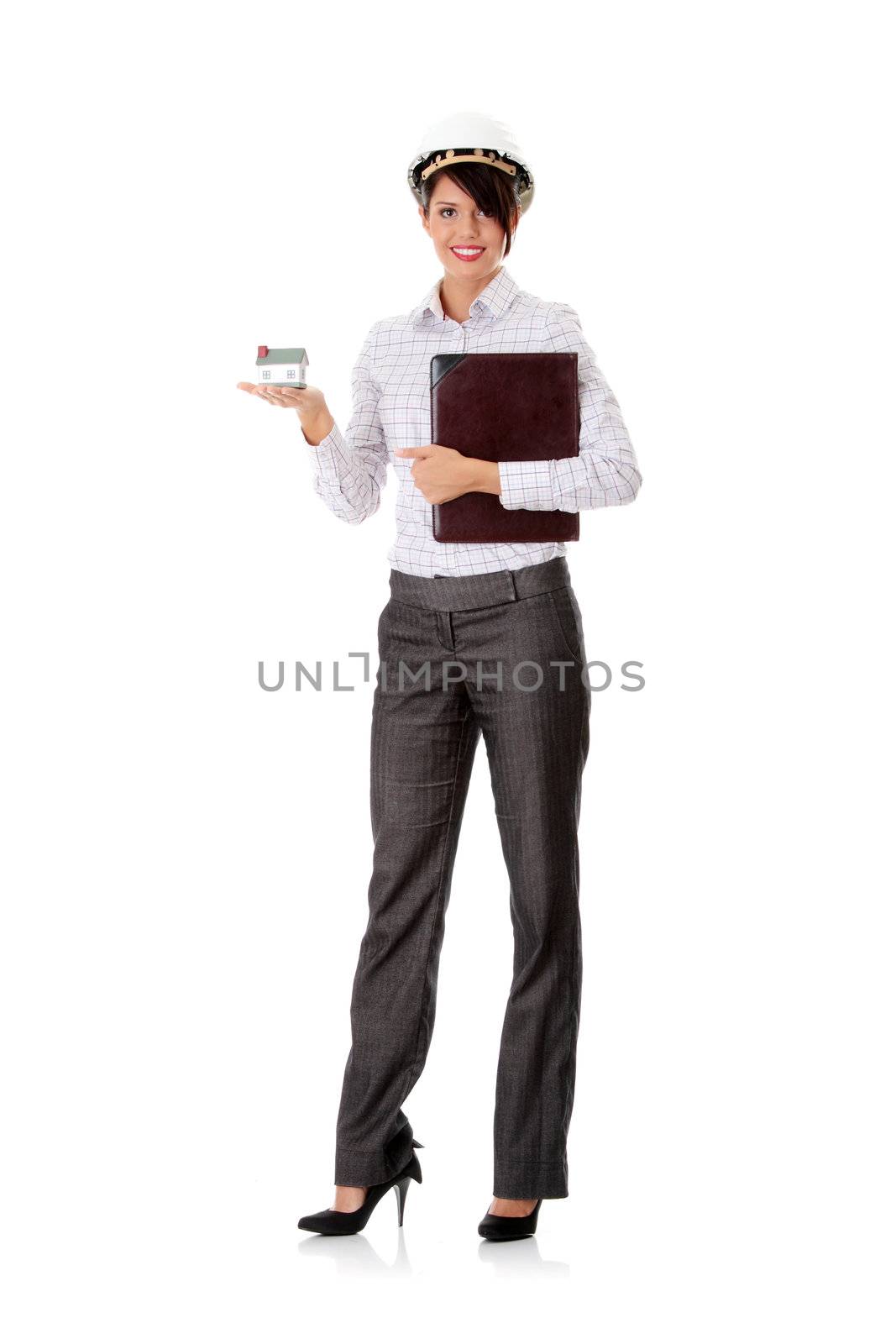 Young businesswoman holding house model, isolated on white background