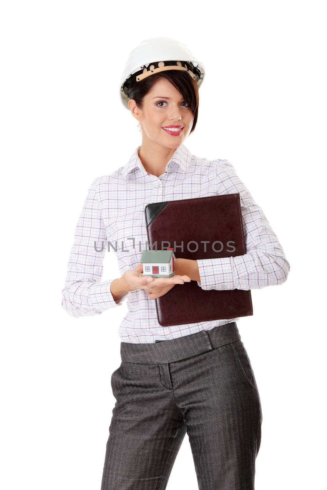 Young businesswoman holding house model, isolated on white background