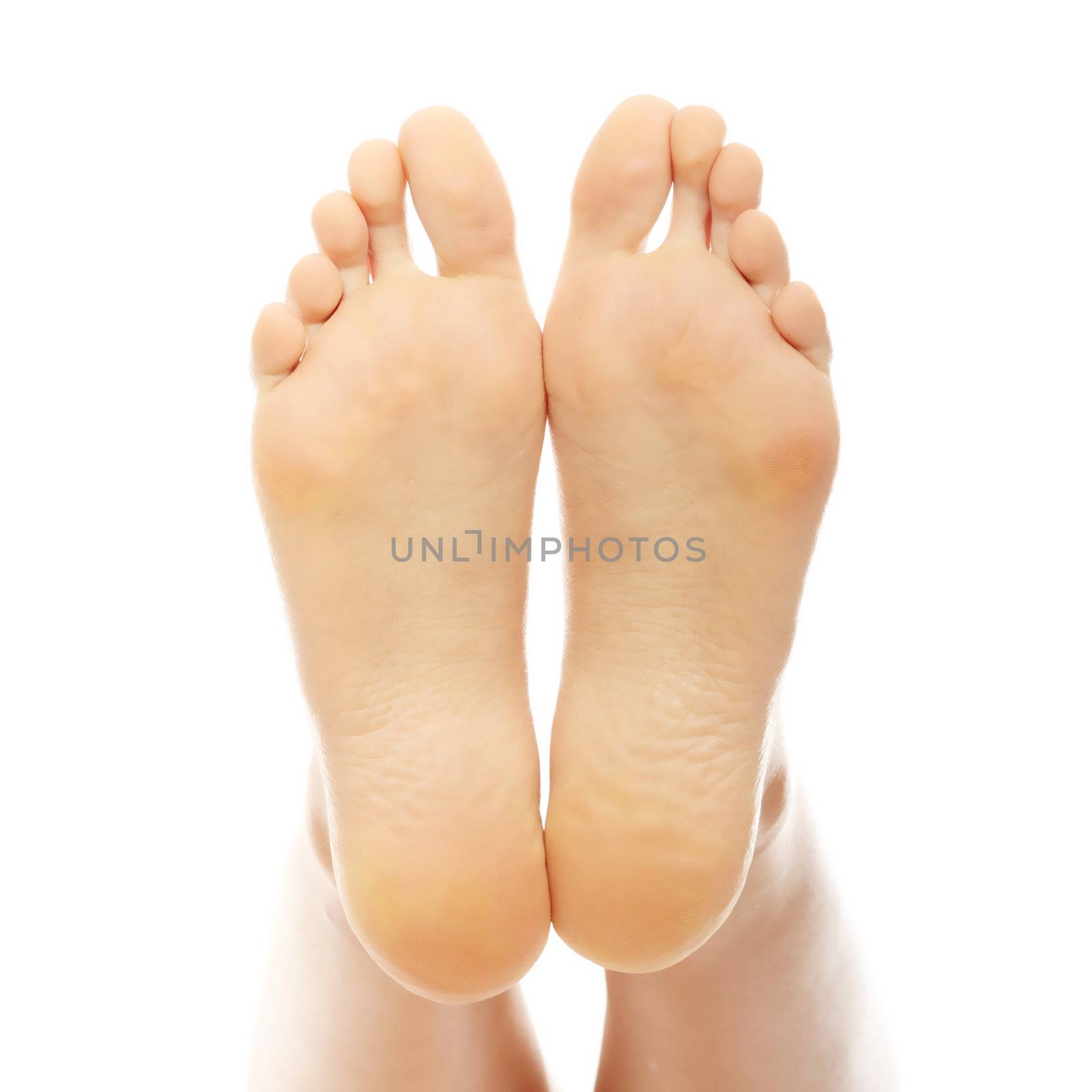 Beautiful female a foot and a heel lifted upwards on a white background