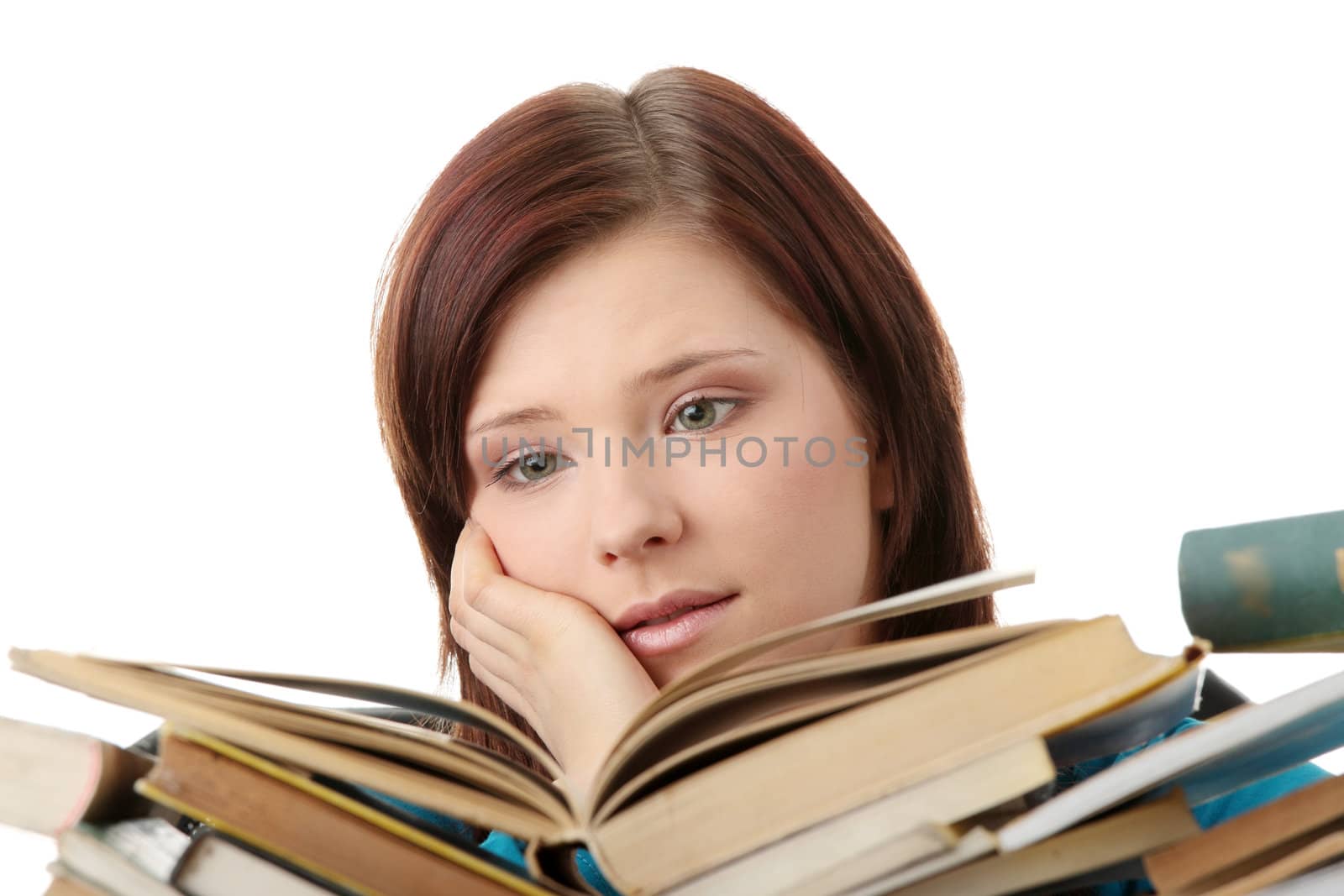 Young woman behind books, isolated on white background