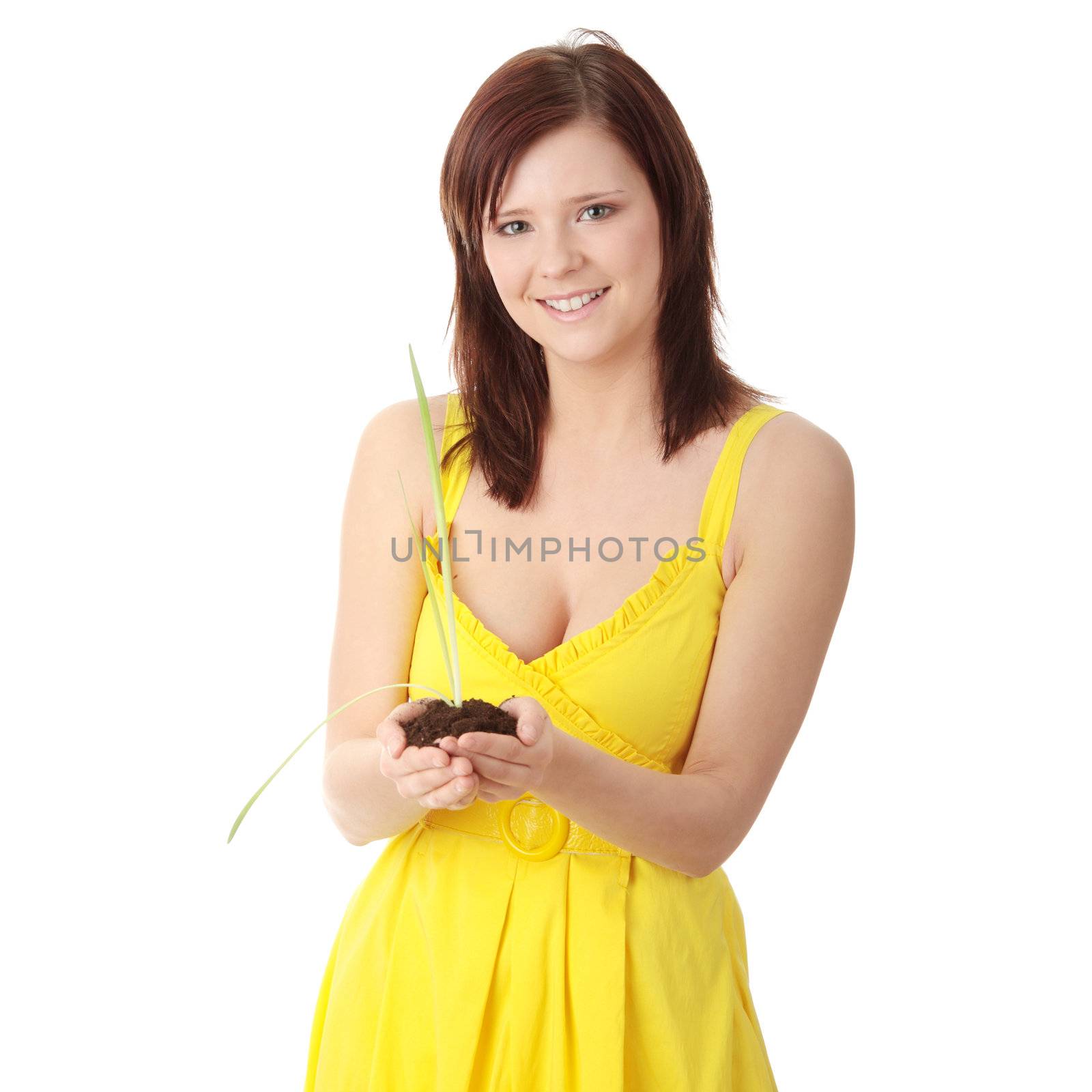 Young woman holding small plant and soil in her hands, isolated on white