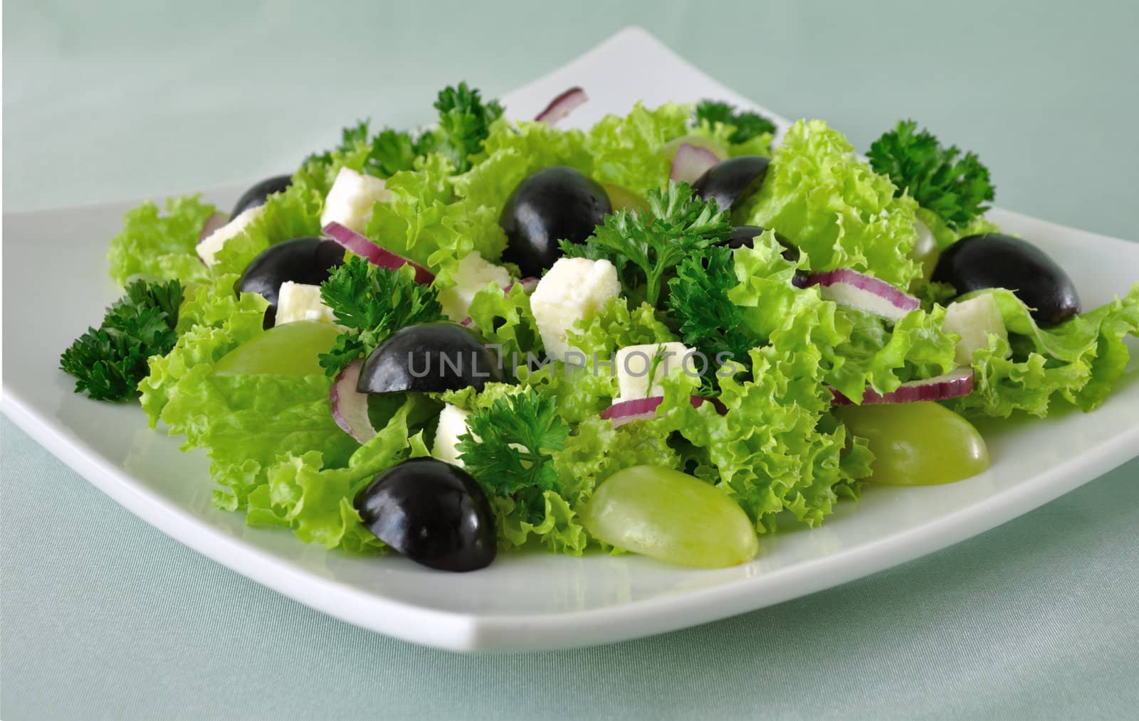 Salad of lettuce with cheese and grapes of different varieties