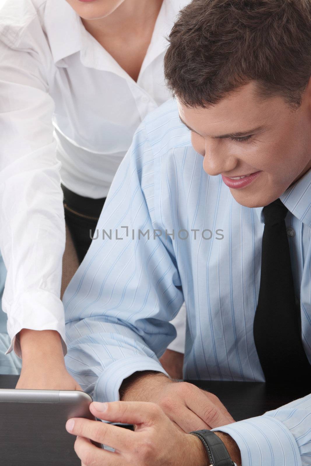 Interracial business team working at laptop in a office, isolated on white