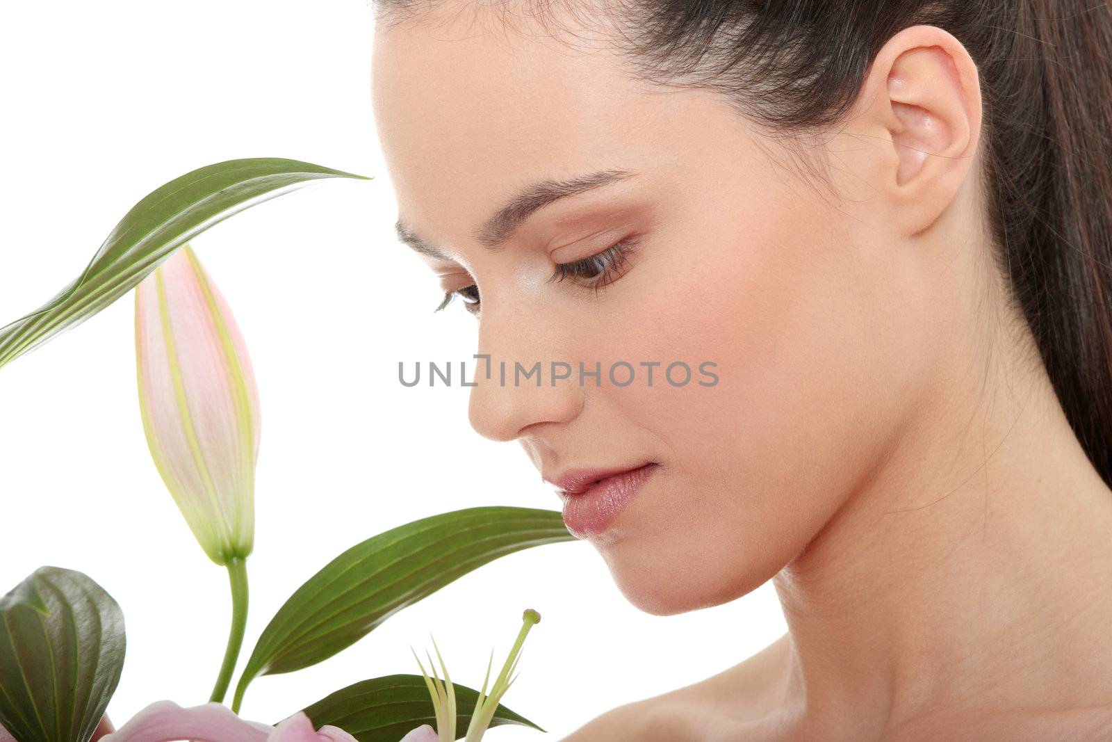 Portrait of the attractive girl without a make-up, with lily flower in hand, isolated on white background 