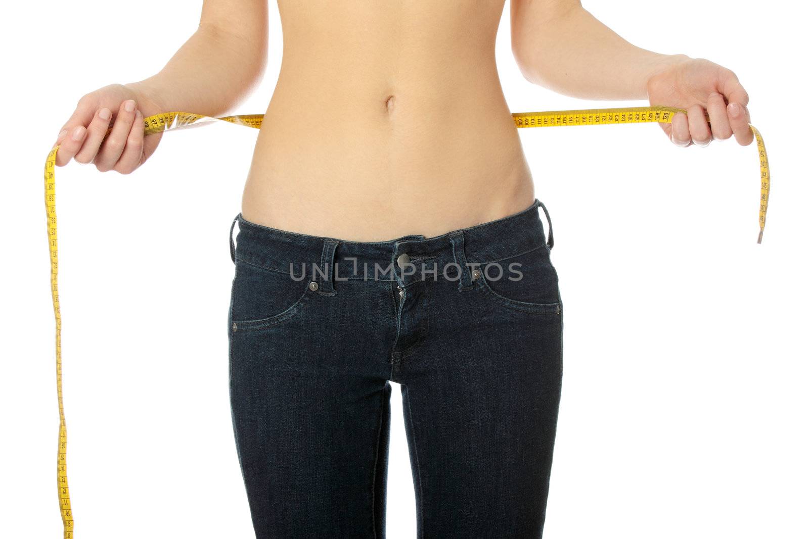 Sexy, fit, young woman measuring her waist, isolated on white