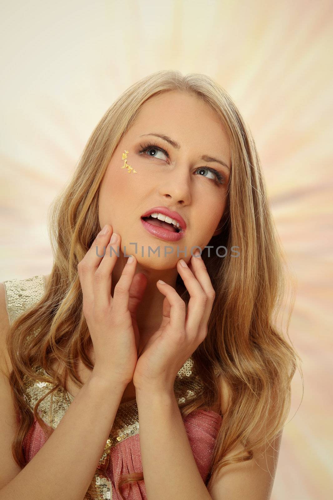 Beautiful young blonde girl against abstract background