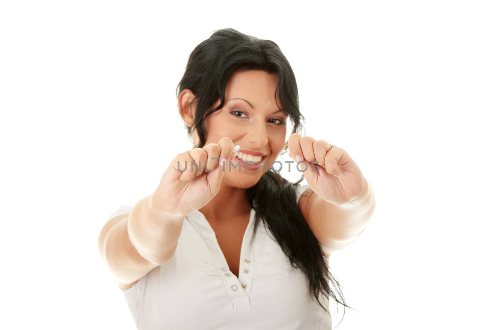 Young woman quiting smoking, isolated on white - focus on hand