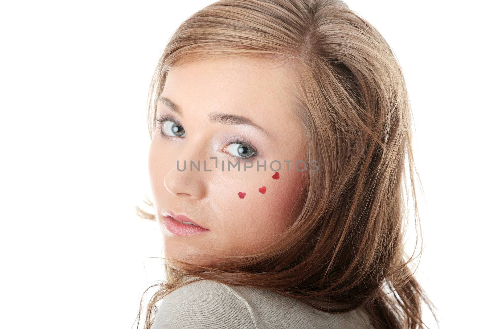 Young caucasian woman with light make up and hearts on face isolated on white background