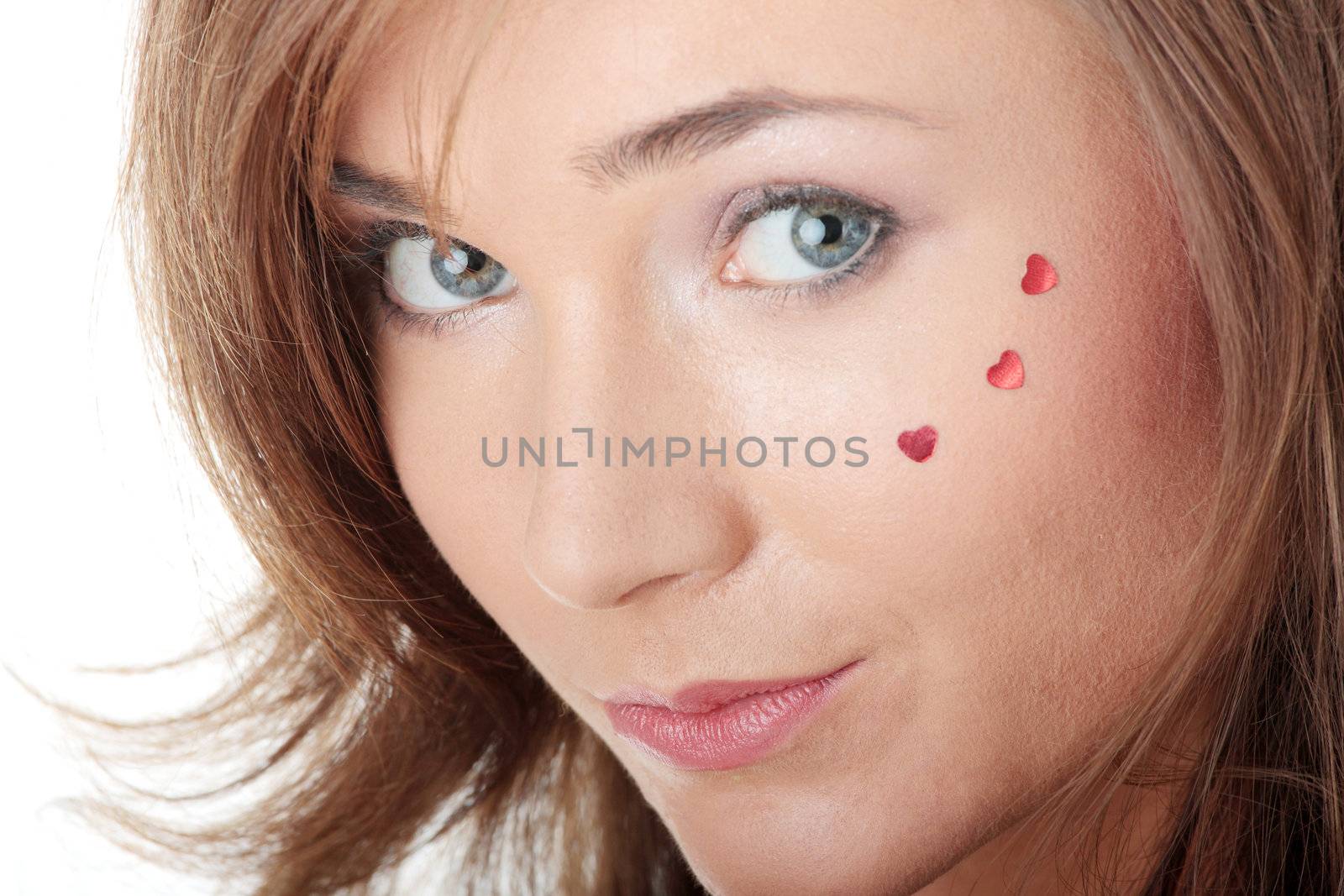 Young caucasian woman with light make up and hearts on face isolated on white background