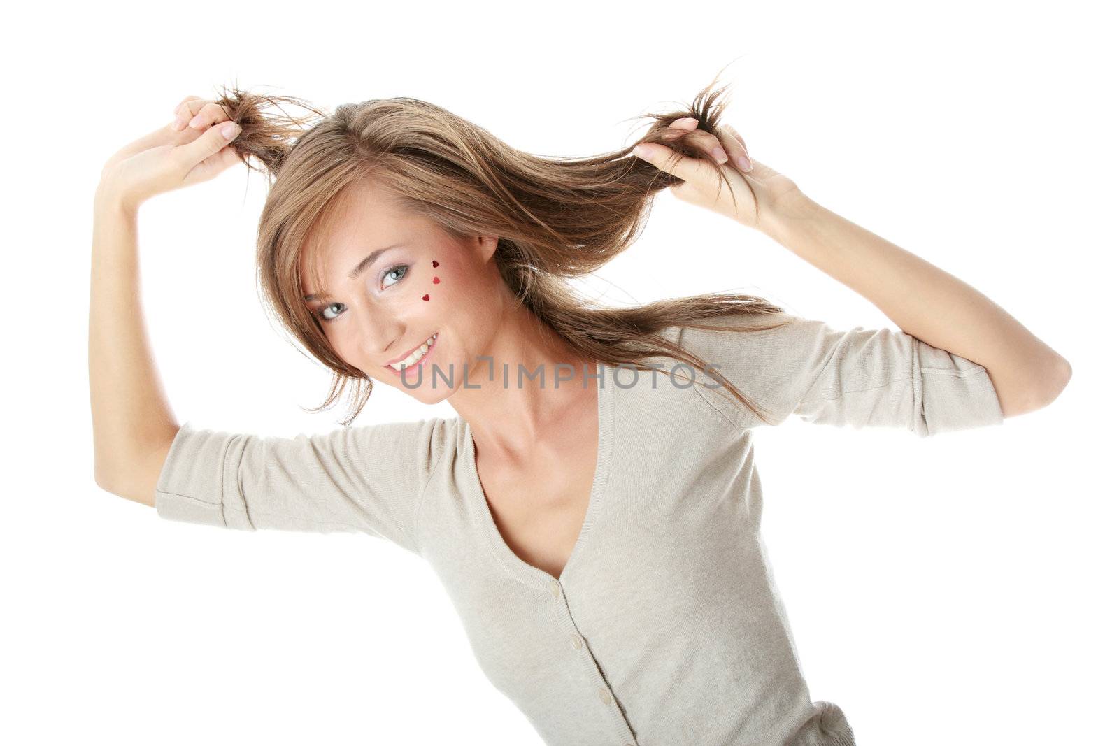 Young caucasian woman with light make up and hearts on face isolated on white background