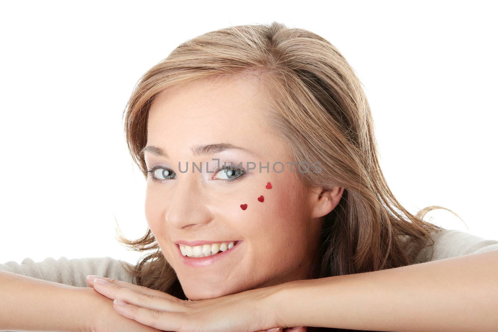 Young caucasian woman with light make up and hearts on face isolated on white background